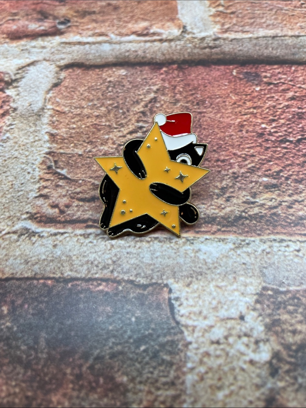 Cute Black Cat Enamel Pin Holding Yellow Star with Santa Hat